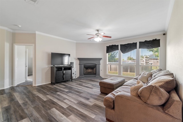 living room featuring ceiling fan, wood-type flooring, and crown molding