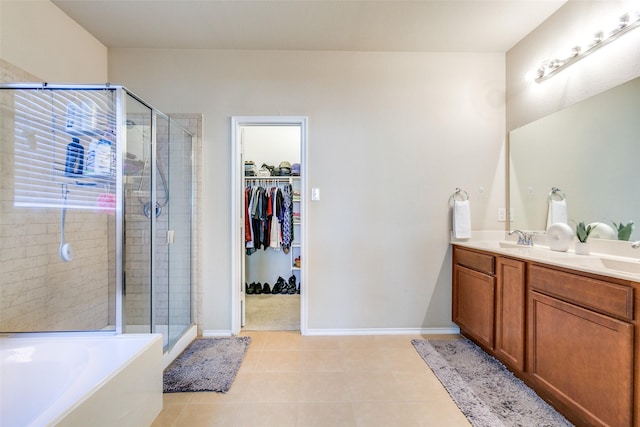 bathroom featuring tile patterned floors, vanity, and shower with separate bathtub