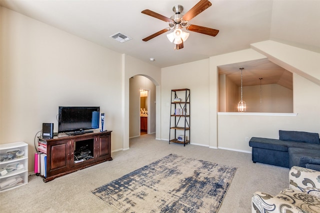 carpeted living room featuring ceiling fan and vaulted ceiling