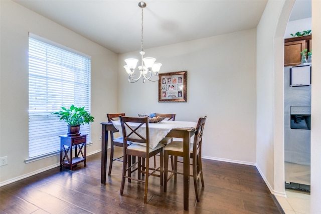 dining room with a notable chandelier and dark hardwood / wood-style floors