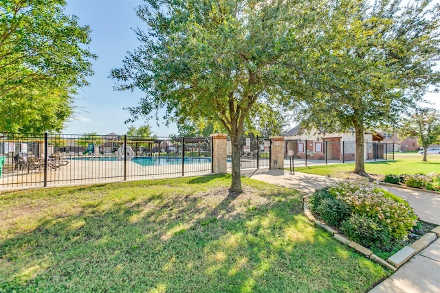 exterior space featuring a lawn and a pool