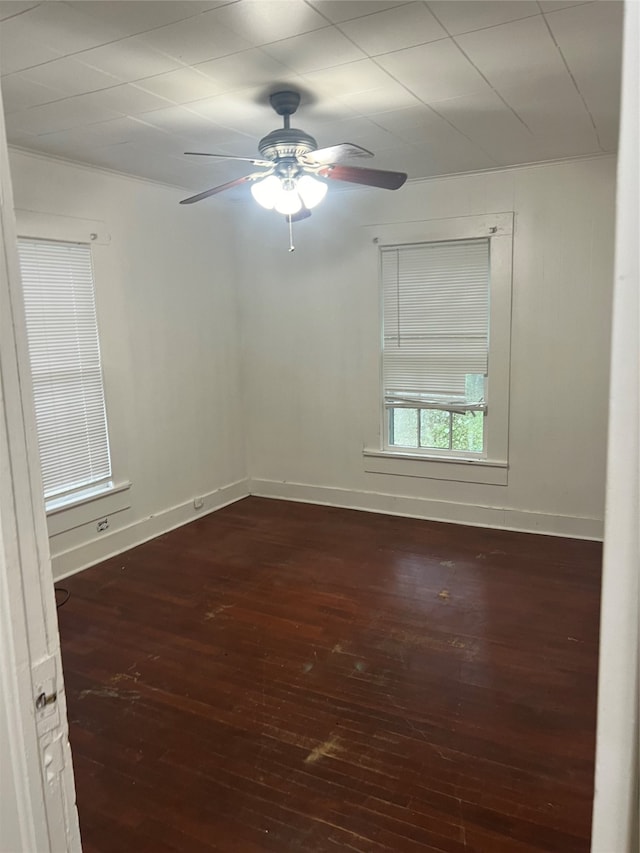 spare room with ornamental molding, ceiling fan, and dark hardwood / wood-style flooring