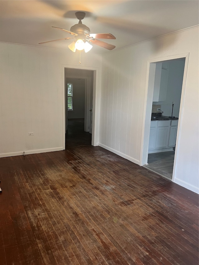 unfurnished room with ceiling fan, ornamental molding, and dark hardwood / wood-style flooring