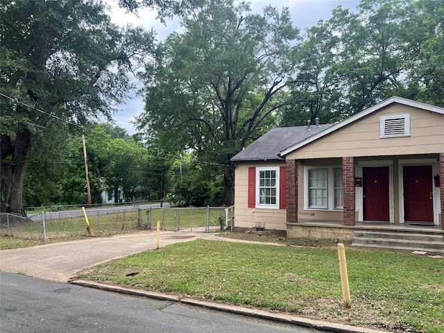 bungalow-style house with a front lawn