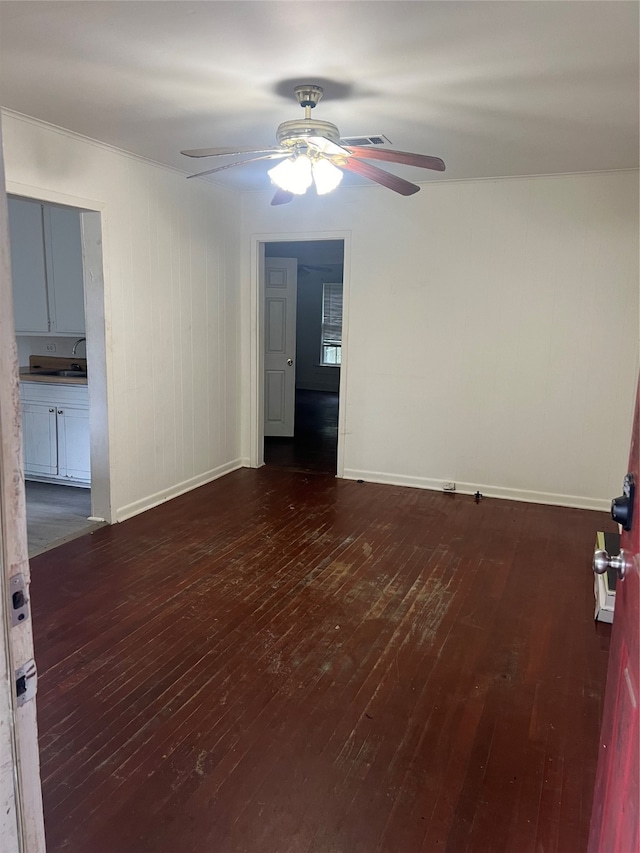 unfurnished room with ceiling fan and dark hardwood / wood-style flooring