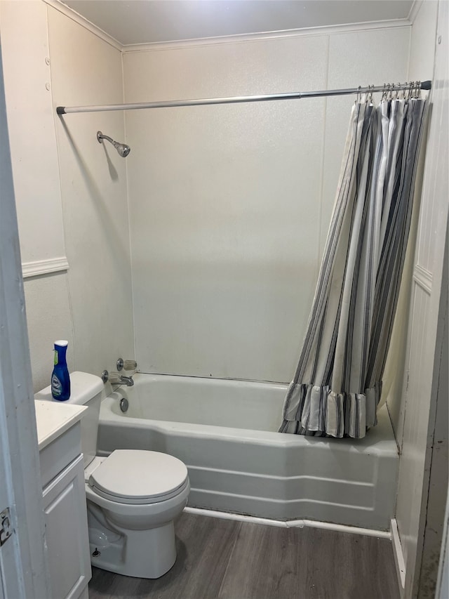 full bathroom featuring hardwood / wood-style floors, vanity, shower / tub combo, and toilet