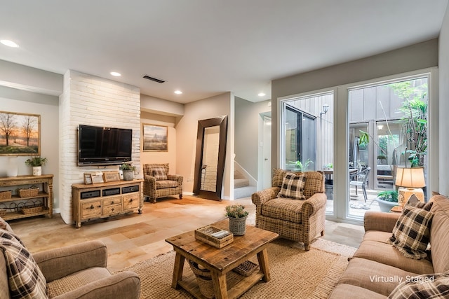 living area featuring visible vents, stairs, baseboards, and recessed lighting