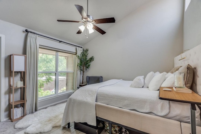 bedroom with lofted ceiling, light colored carpet, and ceiling fan