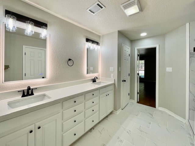 bathroom featuring vanity and a textured ceiling