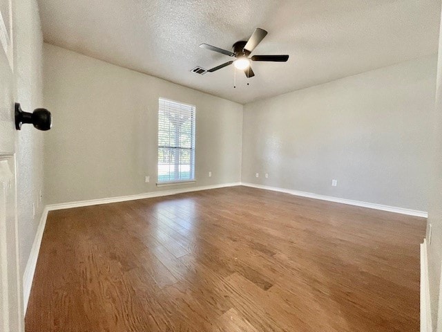 spare room with ceiling fan, hardwood / wood-style flooring, and a textured ceiling