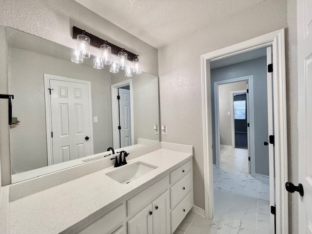 bathroom with vanity and a textured ceiling