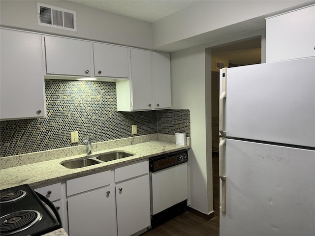 kitchen featuring dark wood-type flooring, sink, white cabinets, decorative backsplash, and white appliances