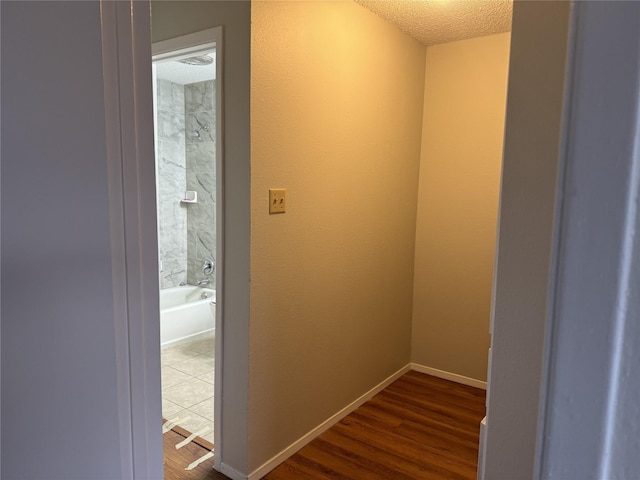 interior space with hardwood / wood-style flooring and a textured ceiling