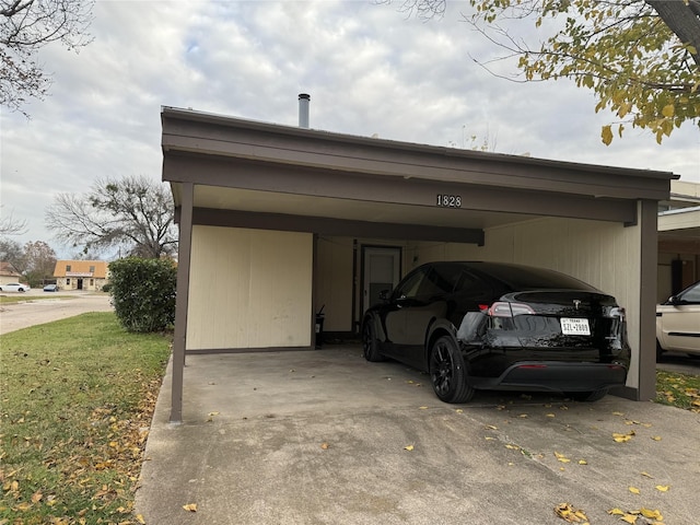 view of vehicle parking with a lawn and a carport