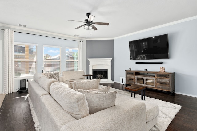 living room with ornamental molding, dark hardwood / wood-style flooring, and ceiling fan