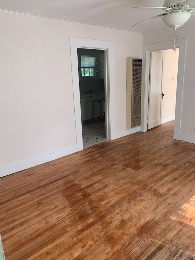 spare room with wood-type flooring, sink, and ceiling fan