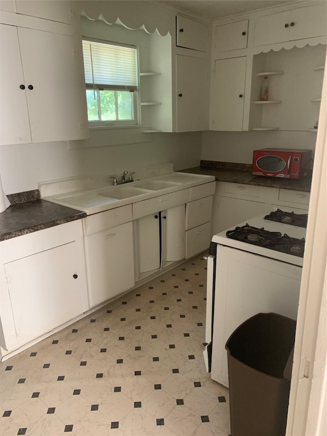 kitchen with white cabinets and gas range gas stove