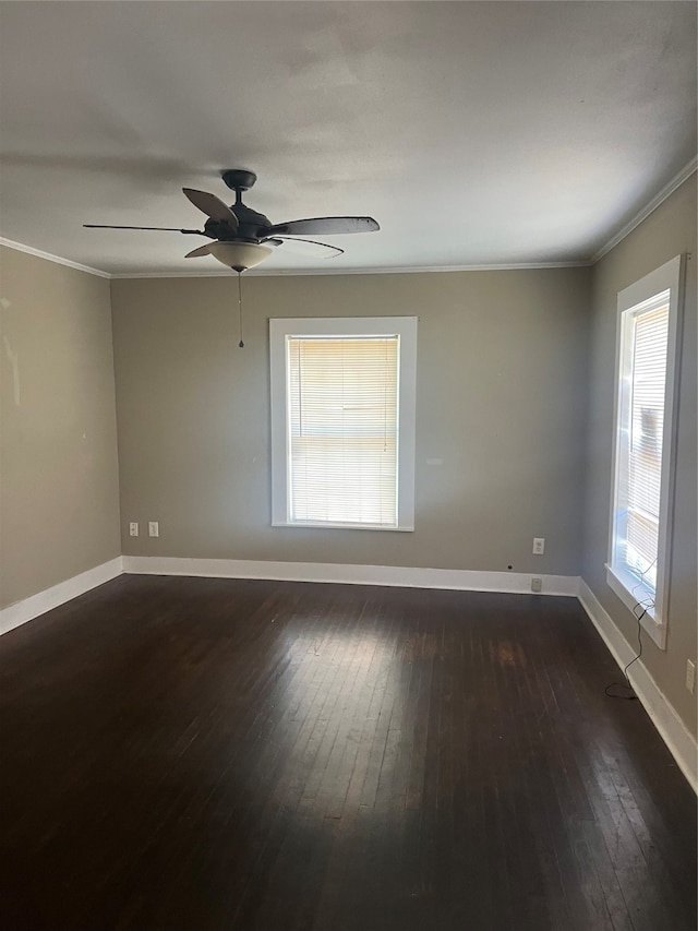 spare room featuring crown molding, ceiling fan, and dark wood-type flooring