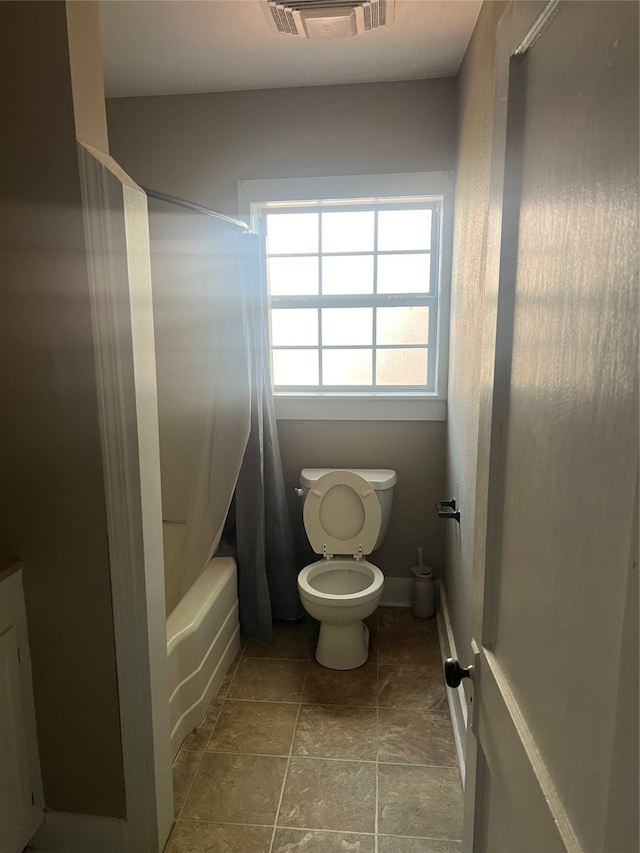 bathroom with toilet and shower / bath combo