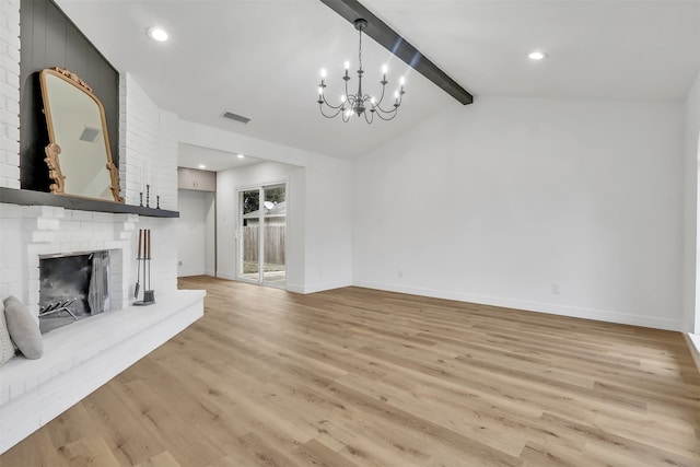 unfurnished living room with a brick fireplace, light wood-type flooring, vaulted ceiling with beams, and a notable chandelier