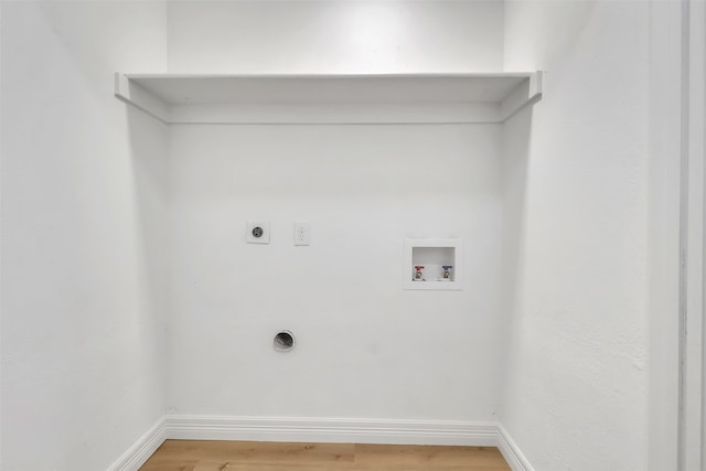 clothes washing area with wood-type flooring, hookup for an electric dryer, and washer hookup