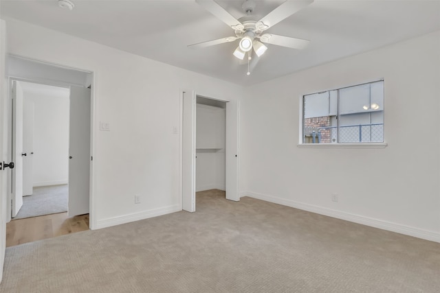 unfurnished bedroom with a closet, ceiling fan, and light colored carpet