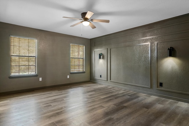 empty room featuring wood-type flooring and ceiling fan