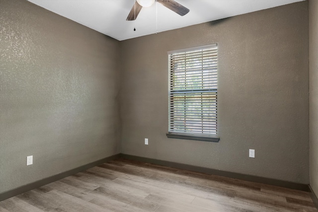 spare room with ceiling fan and light hardwood / wood-style floors