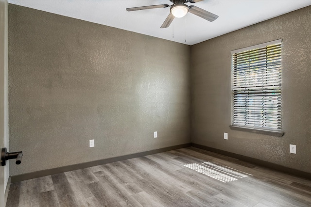 unfurnished room featuring light wood-type flooring and ceiling fan