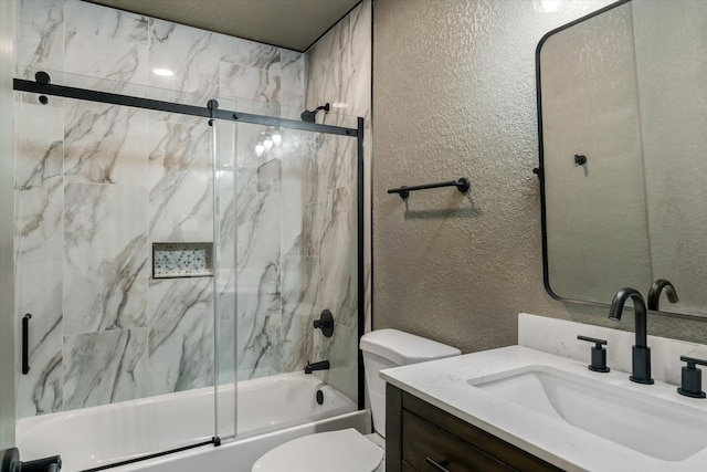 full bathroom with vanity, toilet, and combined bath / shower with glass door