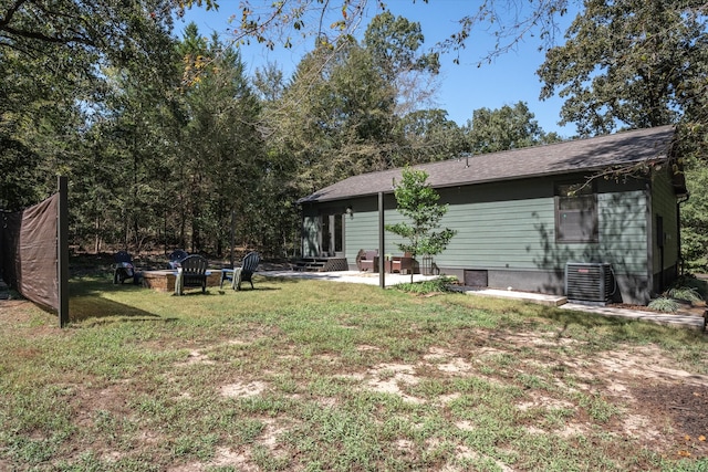 view of yard featuring central AC unit, a patio area, and an outdoor fire pit