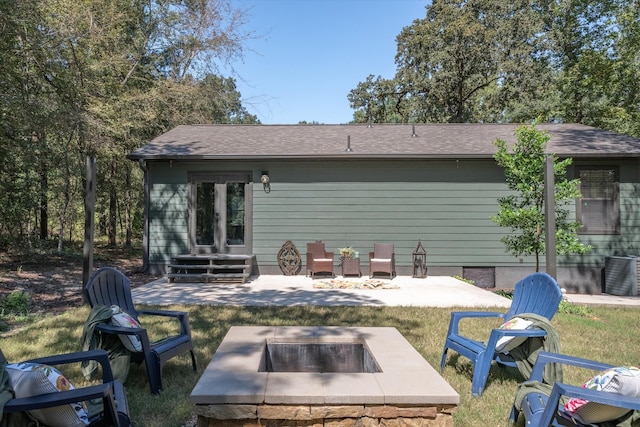 back of property with a patio area and an outdoor fire pit