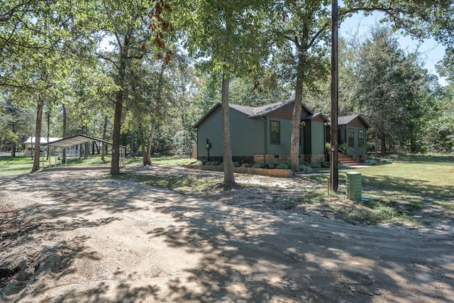 view of side of home with a yard