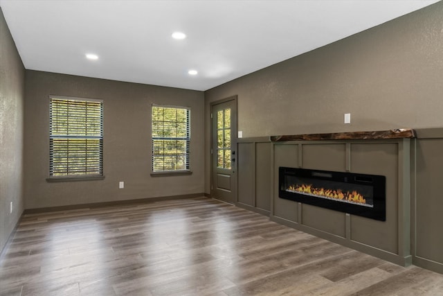 unfurnished living room featuring hardwood / wood-style flooring