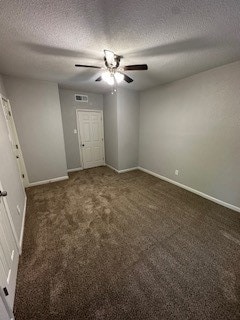 carpeted empty room with ceiling fan and a textured ceiling