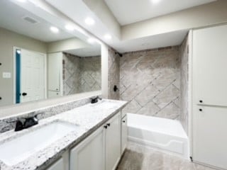 bathroom with vanity and  shower combination