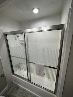 bathroom with shower / bath combination with glass door