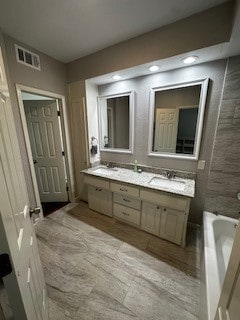 bathroom with a bath and vanity