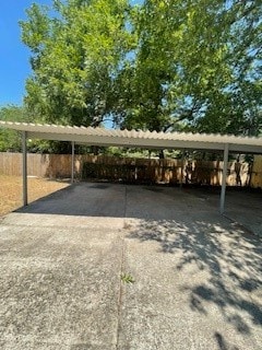 view of parking / parking lot featuring a carport