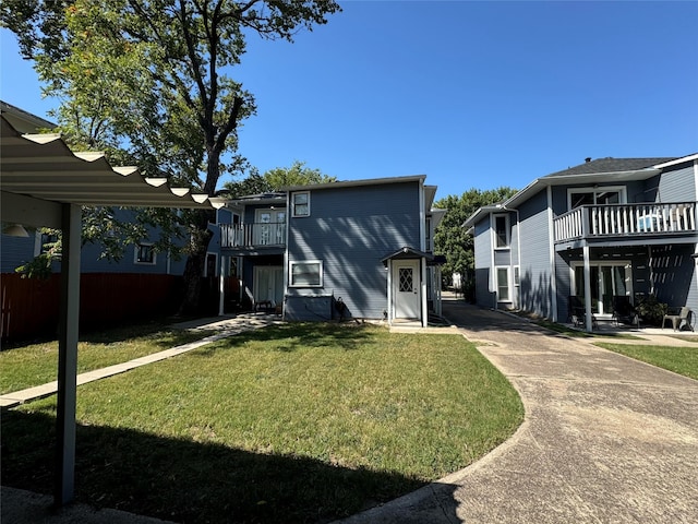 exterior space featuring a balcony and a yard