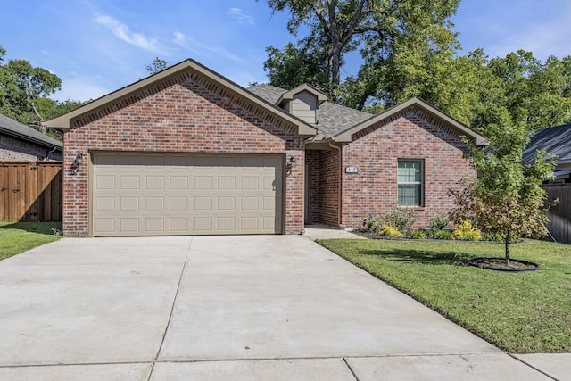 view of front of house with a garage and a front lawn