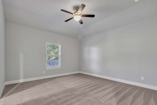 carpeted empty room featuring ceiling fan