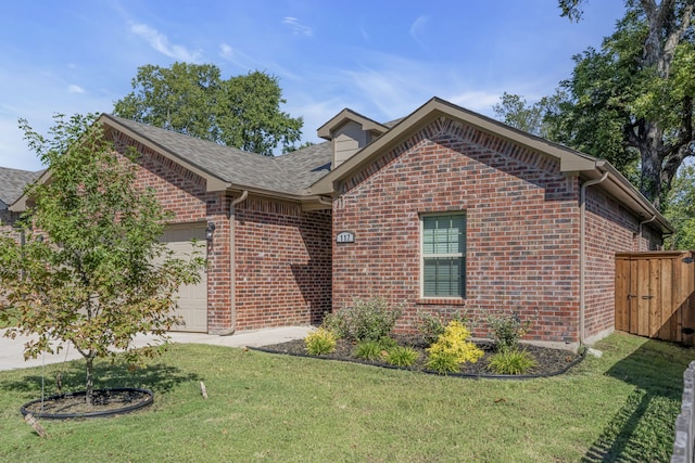 view of front of home with a garage and a front lawn