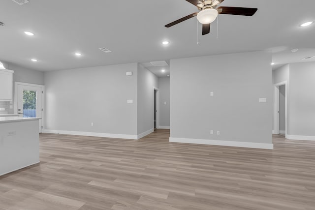 unfurnished living room featuring ceiling fan and light hardwood / wood-style flooring