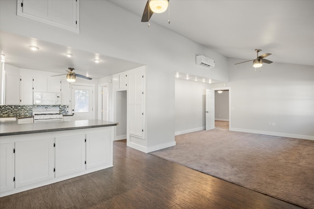 kitchen with dark wood-type flooring, white appliances, white cabinetry, a wall mounted AC, and backsplash