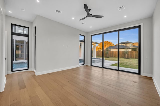 spare room featuring ceiling fan and light hardwood / wood-style flooring