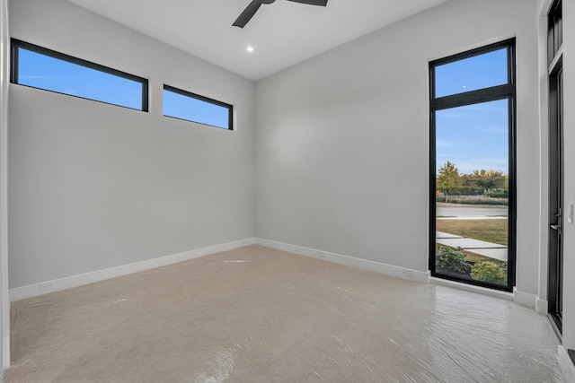 unfurnished room featuring ceiling fan and a wealth of natural light