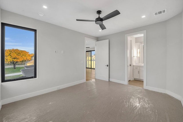 unfurnished bedroom featuring ceiling fan and ensuite bathroom