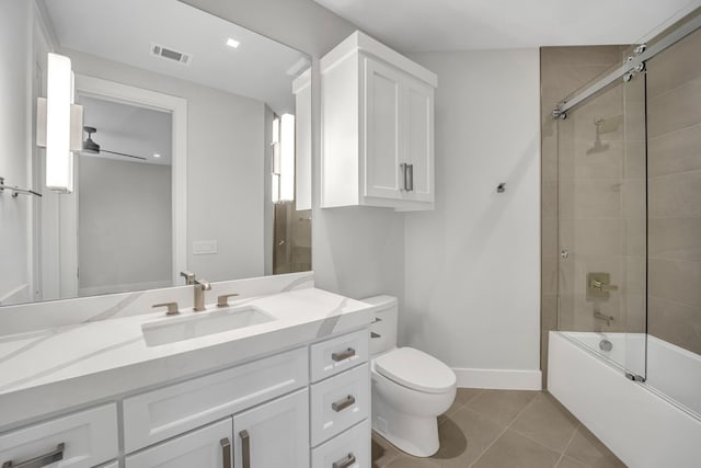 full bathroom featuring toilet, ceiling fan, bath / shower combo with glass door, tile patterned flooring, and vanity