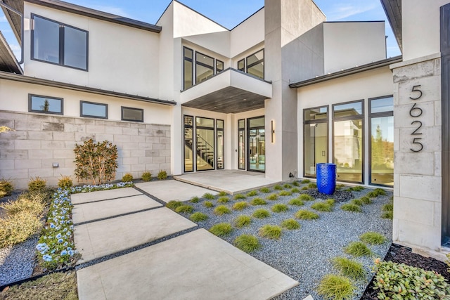 view of exterior entry with a patio